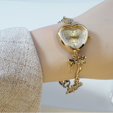 Retro Heart-shaped Bracelet Watch With A Golden Bow And Flower Design A Stylish Womens Timepiece