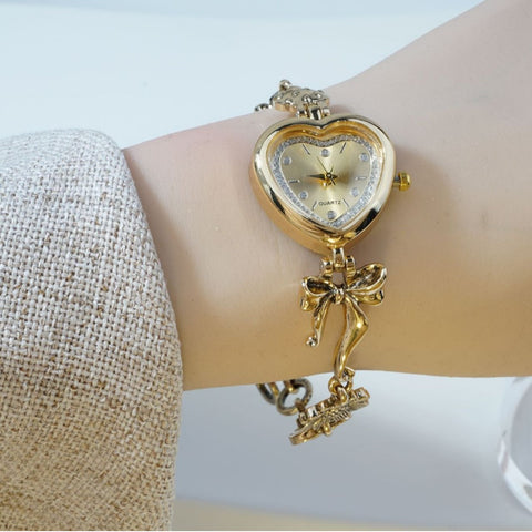 Retro Heart-shaped Bracelet Watch With A Golden Bow And Flower Design A Stylish Womens Timepiece