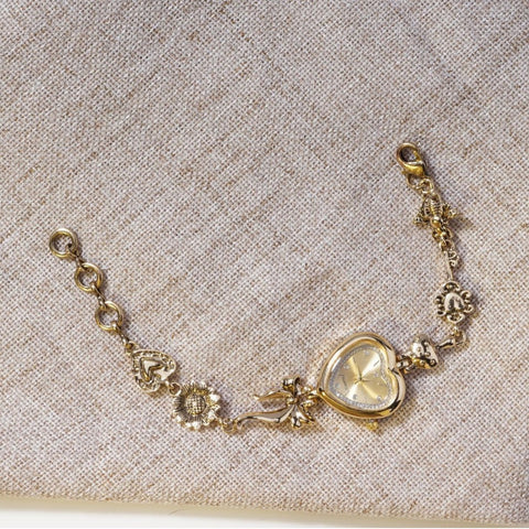 Retro Heart-shaped Bracelet Watch With A Golden Bow And Flower Design A Stylish Womens Timepiece
